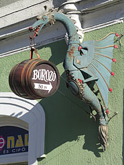 The green dragon figure on the wall, that holds a barrel on its tongue is actually the sign of a wine bar by the lake - Tapolca, Macaristan