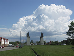 The Tokaj-Hegyalja World Heritage Gate on the main road, with gathering cumulus clouds above it - Szerencs, Ungaria