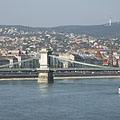The Buda-side of the Széchenyi Chain Bridge ("Lánchíd"), as well as there are houses on the Buda Hills and a TV-tower on the Hármashatár Hill in the background - Budapeszt, Węgry
