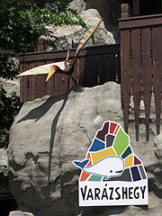 The entrance of the Magical Hill with a plastic ancient flying reptile - Boedapest, Hongarije