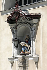 Pietà statue (Virgin Mary cradling the dead body of Jesus Christ) on the wall of the Cathedral - Ljubljana, Slovenia