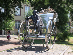 "Home-coming", stainless steel statue at the theater in the park, representing Gyula Krúdy Hungarian writer who was born in Nyíregyháza, sitting on a two-wheeled coach - Nyíregyháza, Ungheria