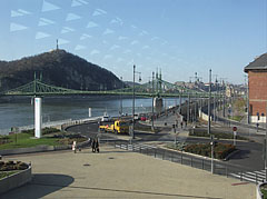 Looking through the glass wall of the Bálna at the Danube bank of Ferencváris district, the Szabadság Bridge (or Liberty Bridge) and the Gellért Hill - Budimpešta, Madžarska