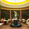 Nice dome hall at the entrance of the Cave Bath building, under the glass dome a fountain and the restaurant tables can be seen - Miskolc, Madžarska