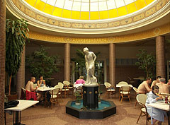 Nice dome hall at the entrance of the Cave Bath building, under the glass dome a fountain and the restaurant tables can be seen - Miskolc, Hongarije