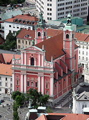 The red-colored twin-towered Franciscan Church, viewed from the castle tower - Ljubljana, Slovenia