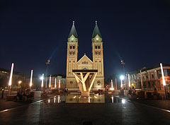 The now completely pedestrian-only main square of Nyíregyháza in the evening, looking towards the illuminated twin-towered Roman Catholic church - Nyíregyháza, Ungaria