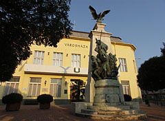 The Town Hall ("Városháza") of Rákospalota, and a World War I monument in front of it, with a legendary turul bird on its top - Budapest, Hungary